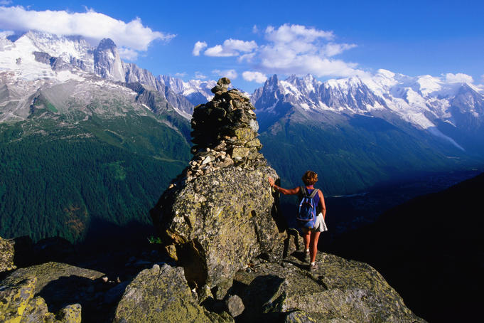 Aiguilles Rouges Natural Reserve trail sign with hiker.