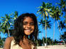 Portrait of young girl on beach with palm trees behind, Colva
