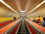 Escalators leading down to underground metro line at Klinikak station, Pest.