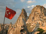 Turkish flag in front of Uchisar Castle.