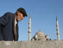 Elderly man walking past Yeni Camii mosque near Galata Bridge, Sultanahmet.