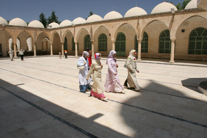 Group of young Turkish women walking through colonnaded courtyard of Hazreti Ibrahim Halilullah.