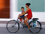 Woman and small boy riding a bicycle.