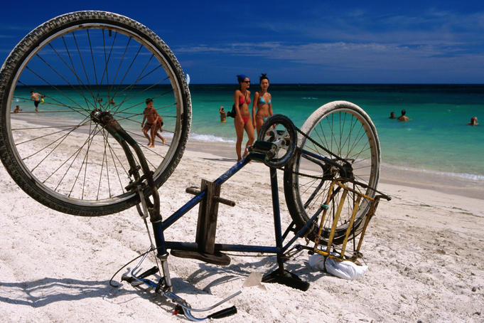 Upturned bike on beach.