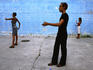 Young Cubans acting as mannequins in a Havana street.