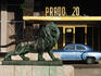 Lion statue on Paseo del Prado (Paseo de Marti) with old car parked in background.