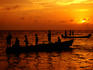 Fishermen waiting to pull nets in as sun sets over Caribbean Sea.