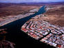 Aerial view of buildings and dry countryside along Colorado River.