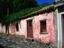 Exterior of historic and weathered pink house.