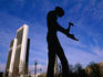 Silhouette of Workman Statue, with Marriott Hotel behind.