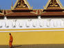 Lone monk passes walls of Royal Palace.