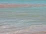 Surfing in red earth-tinted waters, Cable Beach.