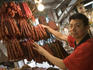Butcher with chourizo Portuguese sausages, Red Market.