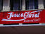 A sign declaring someone's feelings for Jesus Christ, painted on a building in the style of the Coca-Cola logo