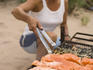 Rafter prepares dinner along Colorado River.