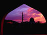 State mosque silhouetted at sunset.