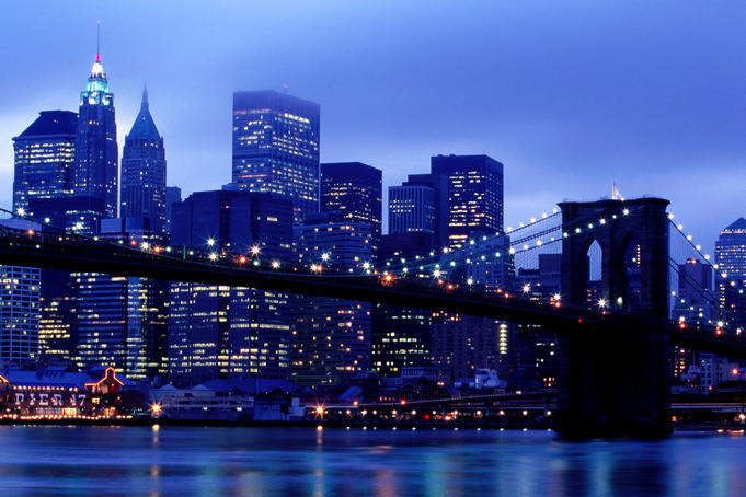 Brooklyn Bridge and Manhattan skyline from Brooklyn at dusk.