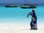 Woman wearing kanga on beach.