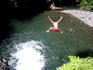 Big jump into deep swimming hole, Togitogiga Waterfall.