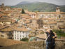 Couple attempt photographing a self portrait with town in backgrownd.