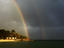 Rainbows over Full Moon resort bar during shower.
