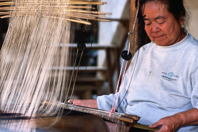 Woman at weaving loom in Baan Phanon village.