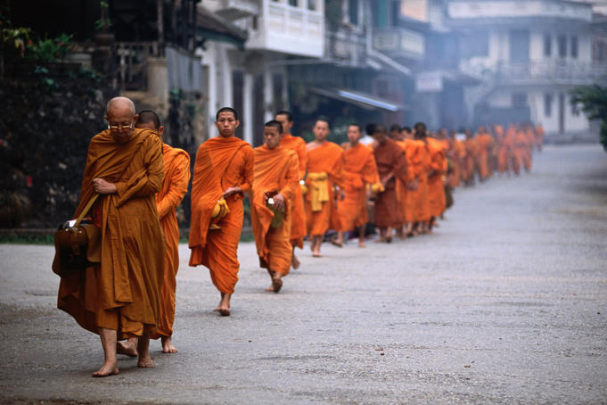 Monks on Tak Baat,or alms round, collecting food in morning.