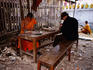 Monks work on Buddhist sculptures at art school in grounds of Wat Xieng Muan.