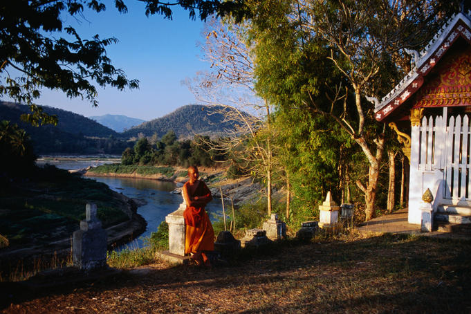 Monk at Wat Sa-at overlooking Nam Khan River.