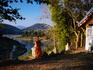 Monk at Wat Sa-at overlooking Nam Khan River.