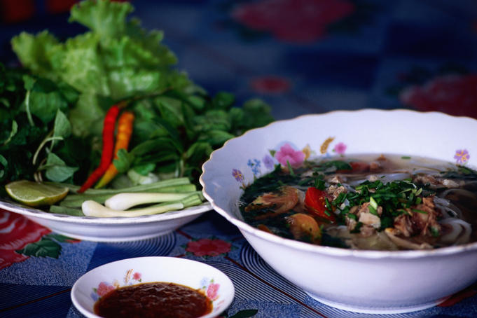 Lao-style noodle soup with shrubbery green sand peanut sauce.