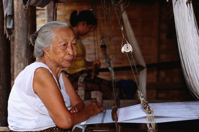Old woman at weaving loom in Baan Phanon village.