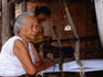 Old woman at weaving loom in Baan Phanon village.