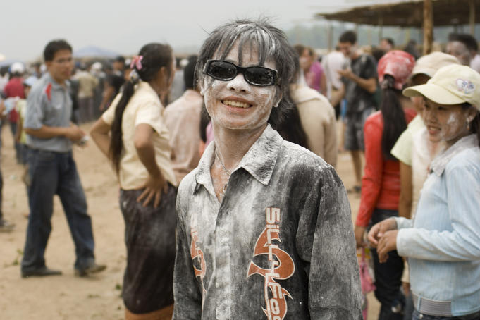 Young people covered in white powder and black paint during Pi Mai Lao ( Lao New Year), Don Sai Mung Khun.