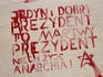 Stencil graffiti on wall in city centre.