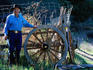 Man standing next to wagon wheel, Post Ranch Inn.