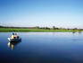 Anglers in boat fishing for Barramundi in Yellow Water Wetlands.