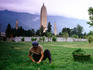 Man tending field in front of Three Pagodas.