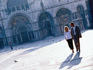 Couple walking in San Marco Plaza.