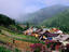 Houses in valley & villagers working in Garden in Listvyanka village on Lake Baikal.
