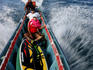 Surfers on way to waves in charter boat.