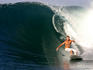 Australian surfer executes bottom turn, Lagundri Bay.