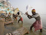 Pounding laundry on banks of the Ganges River.
