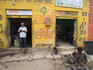 Man standing in doorway of metal working shop.