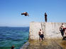Young people jumping off wall at The Suction, Botany Bay.