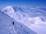 Climber approaching Denali Pass, Mt Foraker in background.