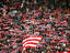Crowd of fans raise scarves in support of Red Star, one of Sebia's premier soccer teams.
