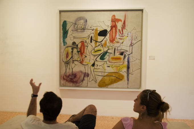 Visitors watching a Gorky's painting in the Peggy Guggenheim Collection.