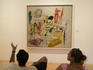 Visitors watching a Gorky's painting in the Peggy Guggenheim Collection.