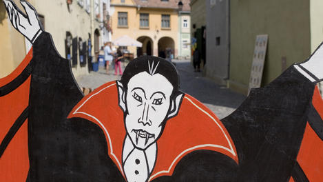 Dracula sign advertising restaurant  in building where Vlad Tepes was born.  Vlad "The Impaler" was inspiration for Bram Stoker's Count Dracula.